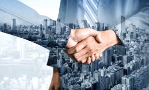 Business handshake with city skyline double exposure representing strategic partnership and enterprise collaboration in urban business environment